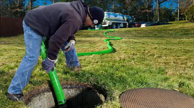 Service technician performing residential septic pumping and drainage maintenance in Duluth, MN